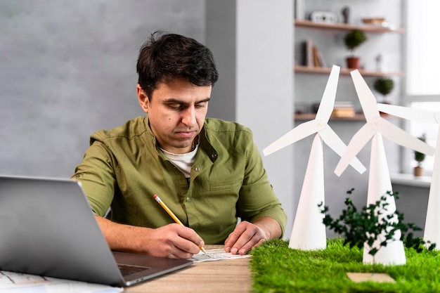 Front view of man working on an eco-friendly wind power project