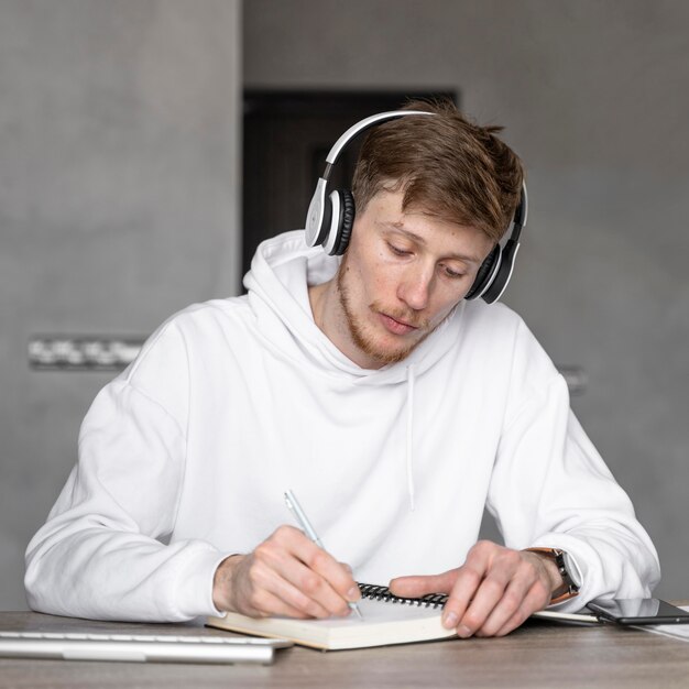 Front view of man working in the media field with headphones