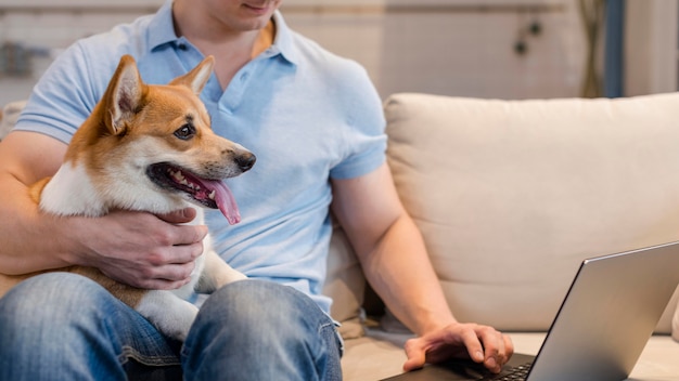 Free photo front view man working while holding dog