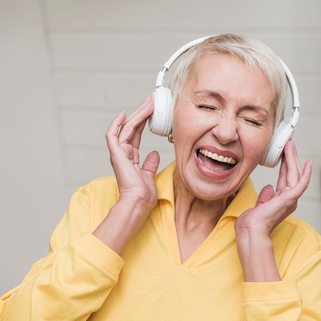 Front view mature woman listening to music