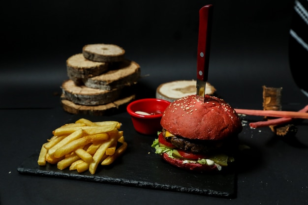 Free Photo front view meat burger with fries ketchup and mayonnaise on a stand with a knife