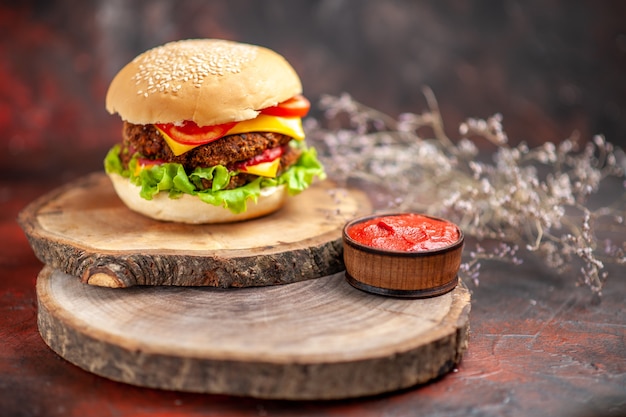 Front view meat burger with salad cheese and tomatoes on dark background