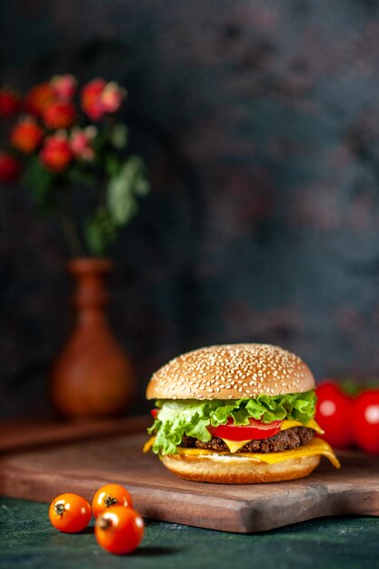 front view meat hamburger with fresh tomatoes on dark background