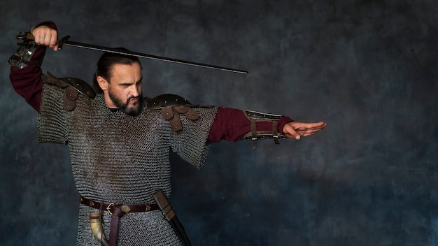 Free photo front view medieval soldier posing in studio