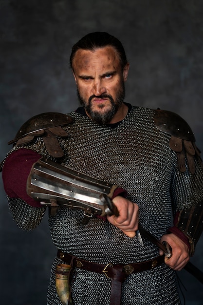 Front view medieval soldier posing in studio