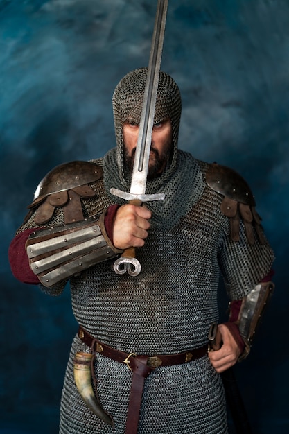 Free photo front view medieval soldier posing in studio