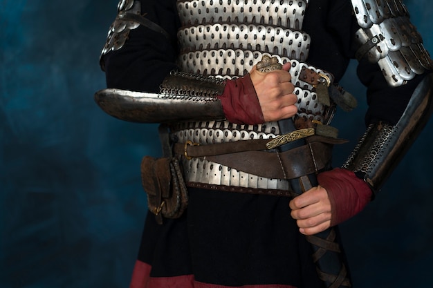 Free photo front view medieval soldier posing in studio