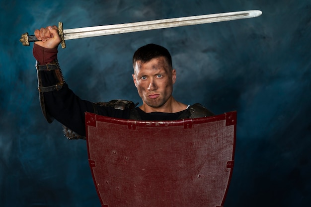 Front view medieval soldier posing in studio