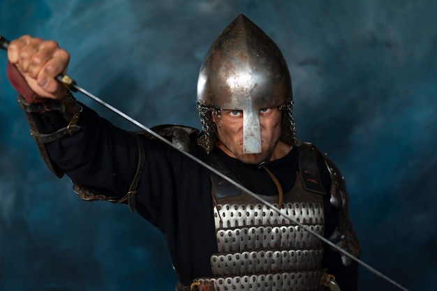 Front view medieval soldier posing in studio