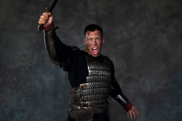 Front view medieval soldier posing in studio