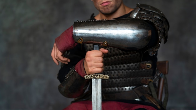 Free photo front view medieval soldier posing in studio