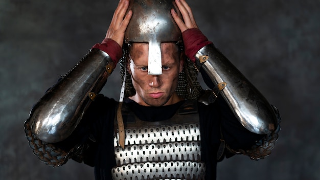 Front view medieval soldier posing in studio