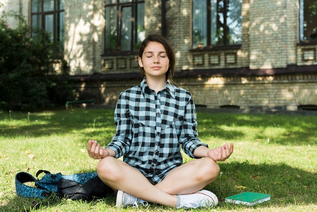 Front view meditating highschool girl