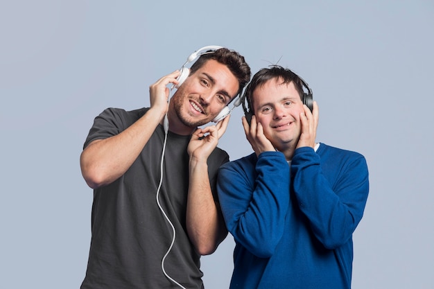 Front view men listening to music through headphones