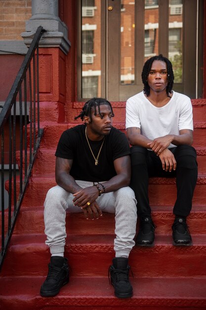 Front view men sitting on stairs