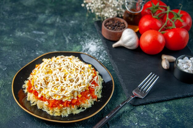 front view mimosa salad inside plate with seasonings and red tomatoes on a dark blue surface kitchen photo cuisine birthday food holiday meal color