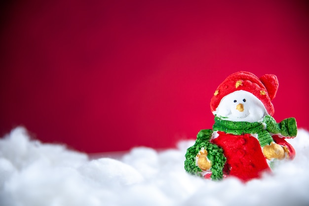 Free Photo front view mini snowman on red background