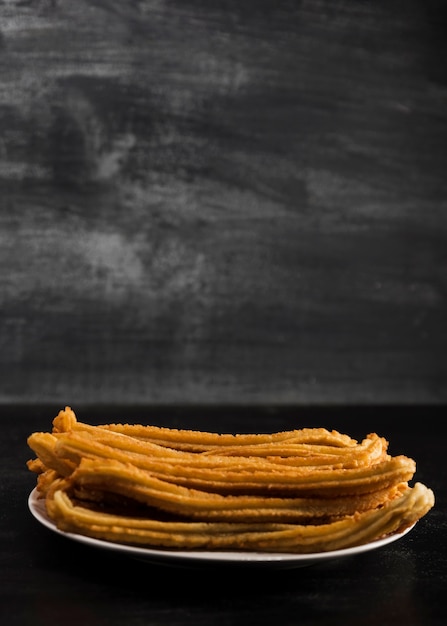 Free photo front view minimalist churros plate with copy space