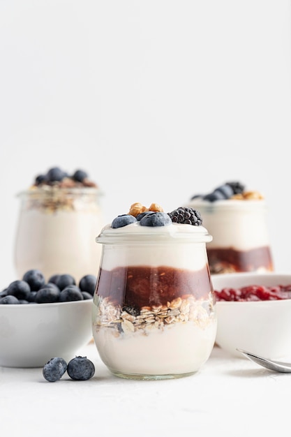 Front view mix of yogurt with fruits, oats and jam