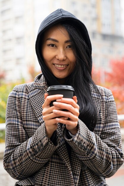 Front view model holding coffee cup