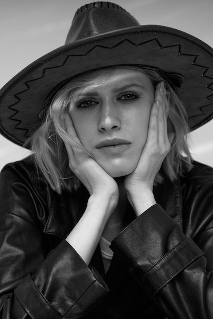 Free Photo front view model posing with hat black and white