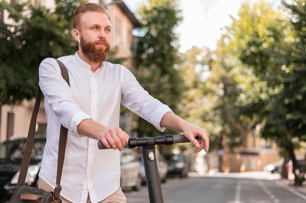 Front view modern man on scooter with copy space