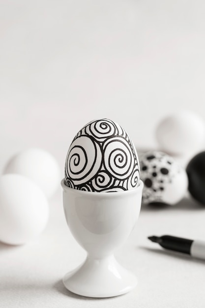 Free Photo front view of monochrome egg for easter in egg cup with copy space