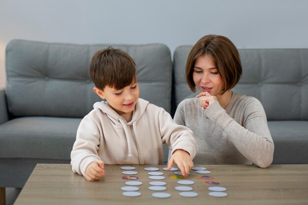 Front view mother and boy playing game