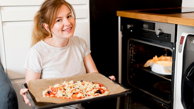 Free photo front view of mother cooking at home