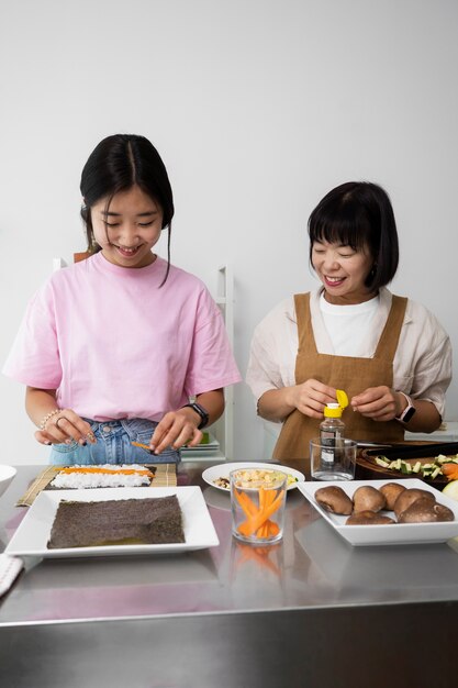 Front view mother and daughter cooking