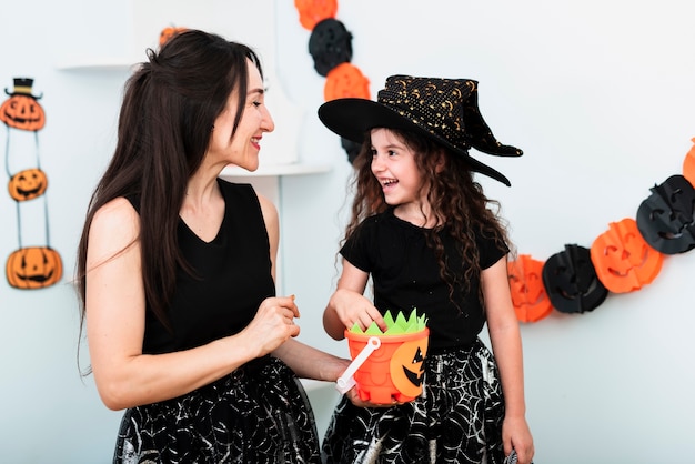 Free photo front view of mother and daughter looing at each other