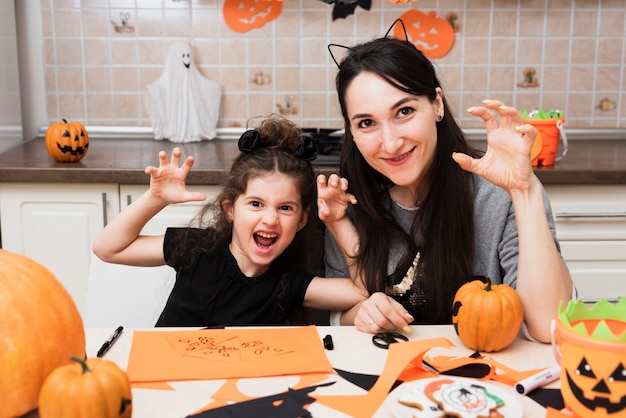 Front view of mother and daughter looking at camera