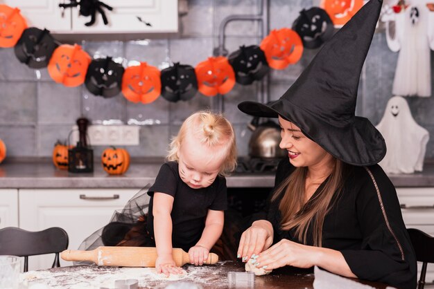 Front view of mother and daughter making cookies