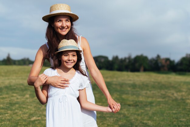 Front view mother and daughter outdoors