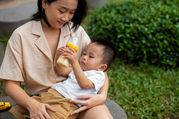 Front view mother holding baby