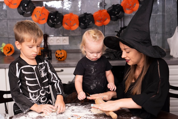 Free photo front view of mother and kids making cookies