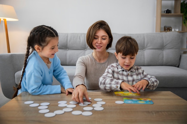 Front view mother and kids playing memory game