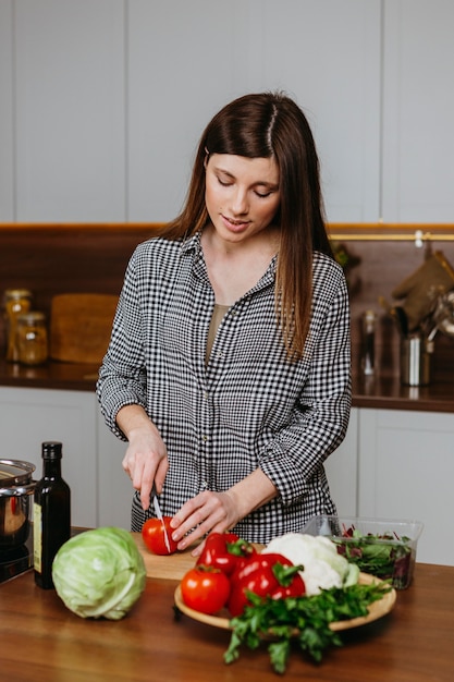 Free Photo front view of mother preparing food in the kitchen