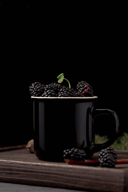 Front view of mug with blackberries