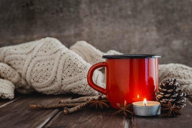 Free Photo front view mug with candle and pullober