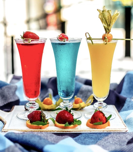 Front view multi-colored cocktails with fruit decor