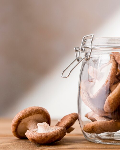 Front view of mushrooms in clear jar with copy space