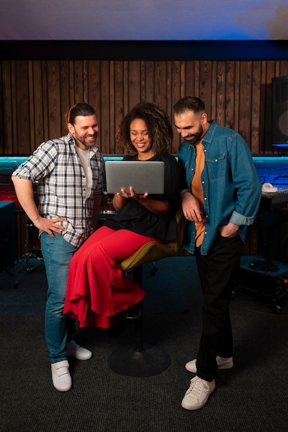 Front view musicians working with laptop