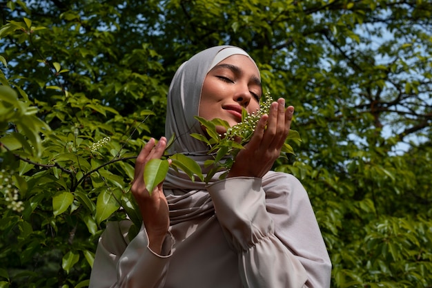 Free photo front view muslim woman posing outdoors