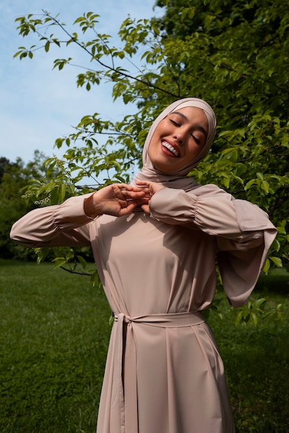 Free photo front view muslim woman posing outdoors