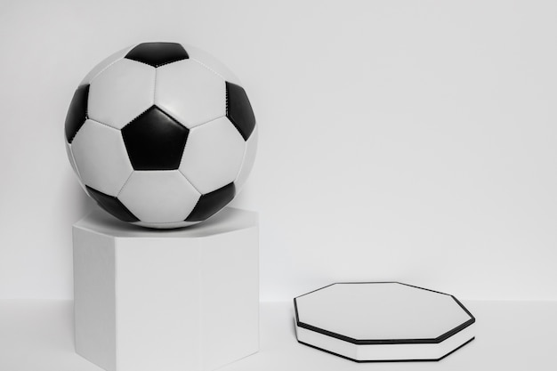 Free photo front view of new football on pedestal with copy space