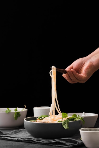 Free photo front view of noodles in bowl with copy space