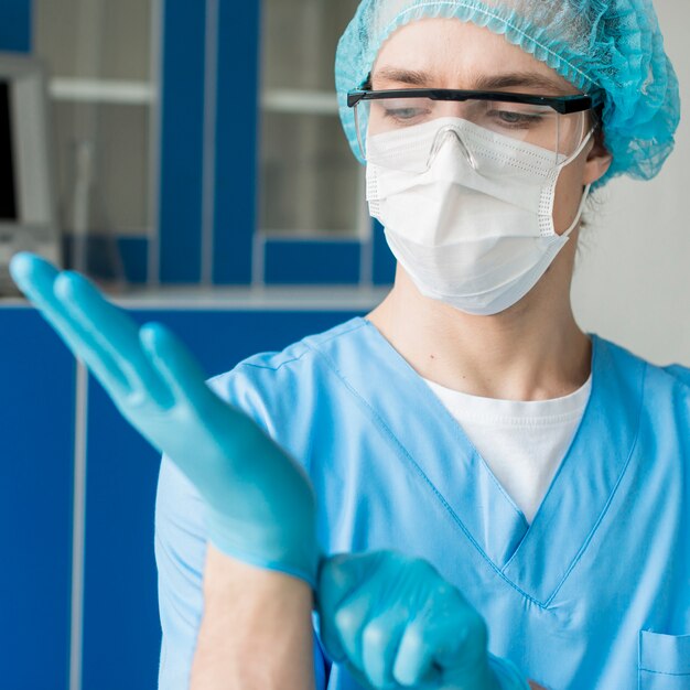 Front view nurse putting on gloves