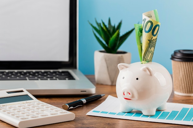 Front view of office items with growth chart and piggy bank