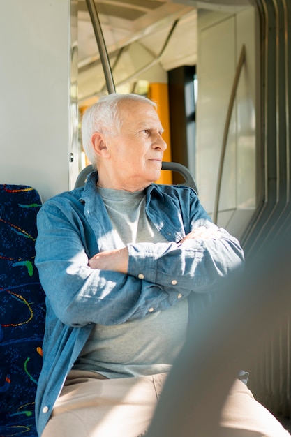 Free Photo front view of old man in public transportation